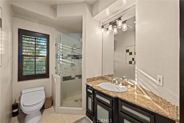 bathroom with tile patterned flooring, vanity, toilet, and walk in shower