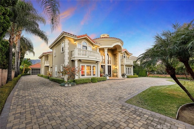 mediterranean / spanish-style house with french doors and a balcony