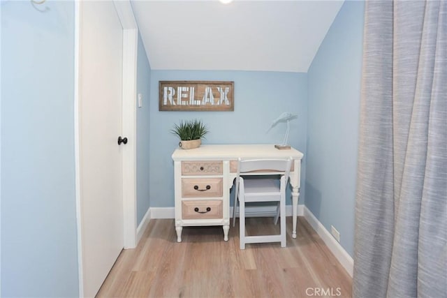 office area featuring vaulted ceiling and light hardwood / wood-style flooring