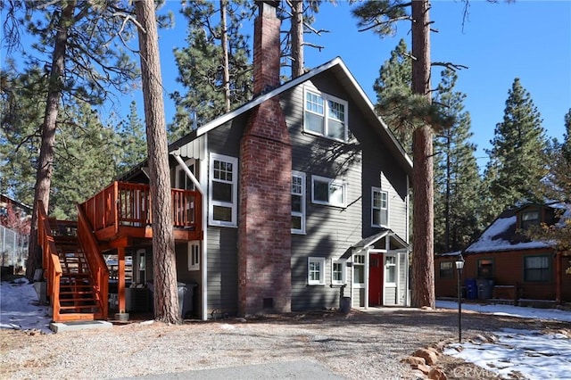 view of side of property with a wooden deck