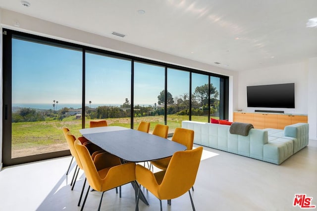 dining area featuring a healthy amount of sunlight and concrete floors