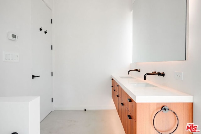 bathroom featuring vanity and concrete flooring