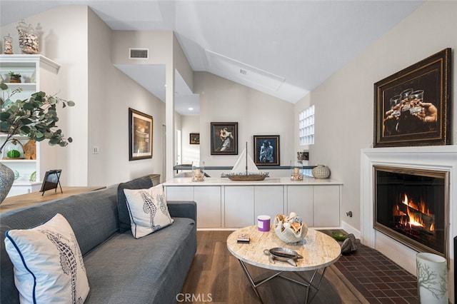 living room with hardwood / wood-style flooring and vaulted ceiling