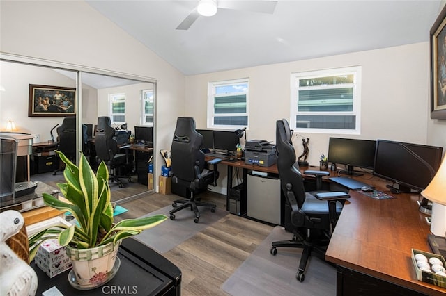 office area featuring light hardwood / wood-style floors, ceiling fan, and lofted ceiling