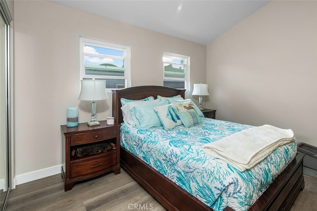 bedroom with hardwood / wood-style flooring and vaulted ceiling