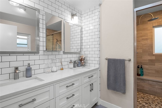 bathroom with vanity, tasteful backsplash, and walk in shower