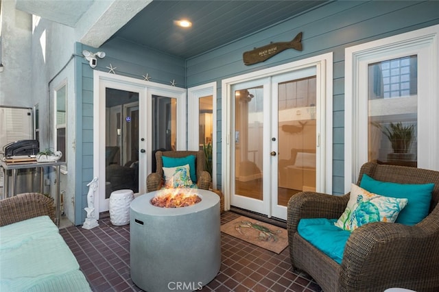 view of patio / terrace with french doors and a fire pit