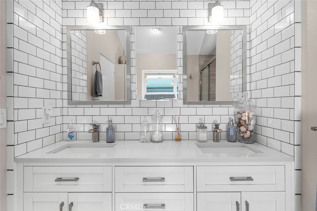 bathroom with decorative backsplash, vanity, and a shower with door