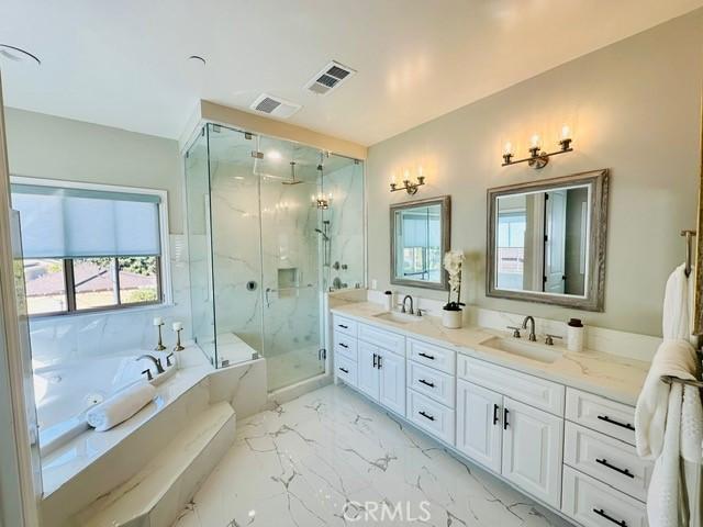 bathroom featuring vanity and plus walk in shower