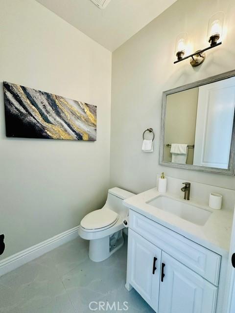 bathroom featuring vanity and toilet