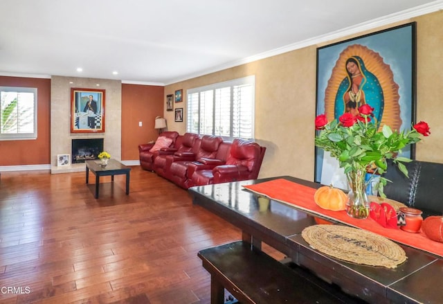 living room with dark hardwood / wood-style flooring, crown molding, and plenty of natural light