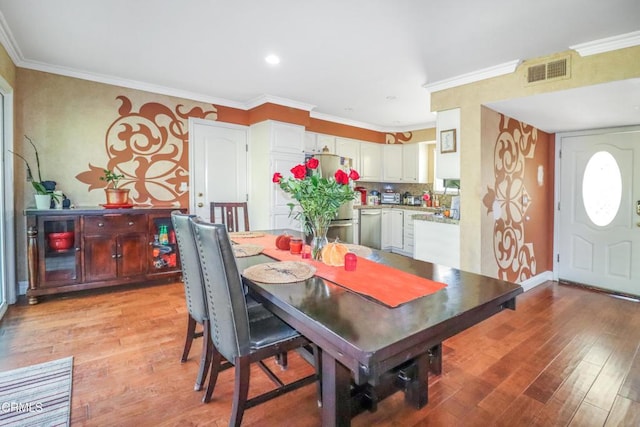 dining space featuring light hardwood / wood-style floors and ornamental molding