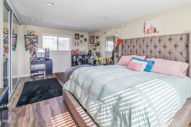 bedroom featuring recessed lighting and wood finished floors