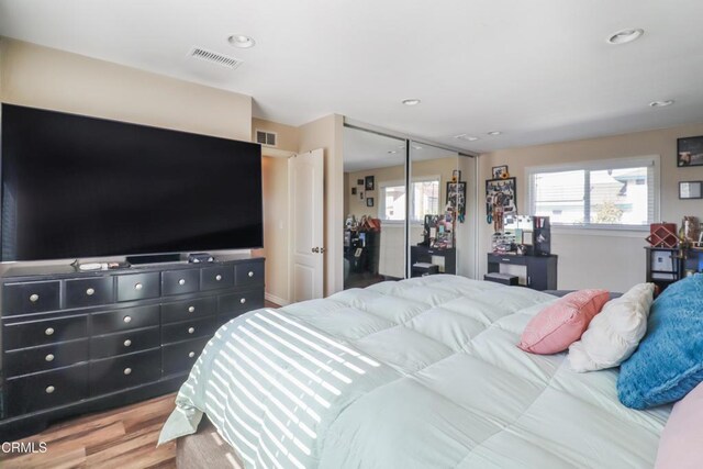 bedroom featuring recessed lighting, visible vents, and wood finished floors