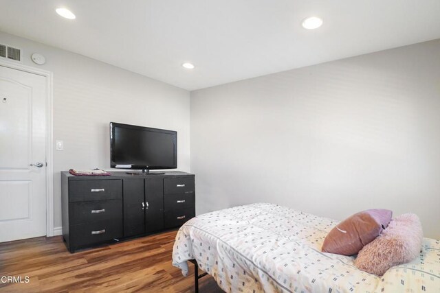 bedroom featuring visible vents, recessed lighting, and wood finished floors