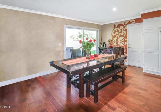 dining room with baseboards, ornamental molding, recessed lighting, and wood finished floors