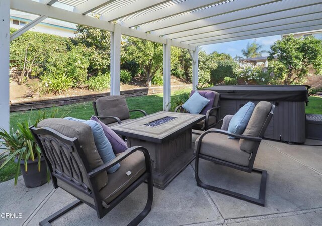 view of patio / terrace with a hot tub, a pergola, and an outdoor fire pit