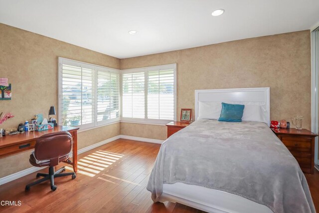 bedroom with recessed lighting, baseboards, and hardwood / wood-style floors