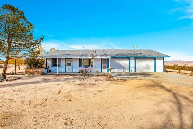 back of property featuring covered porch and a garage