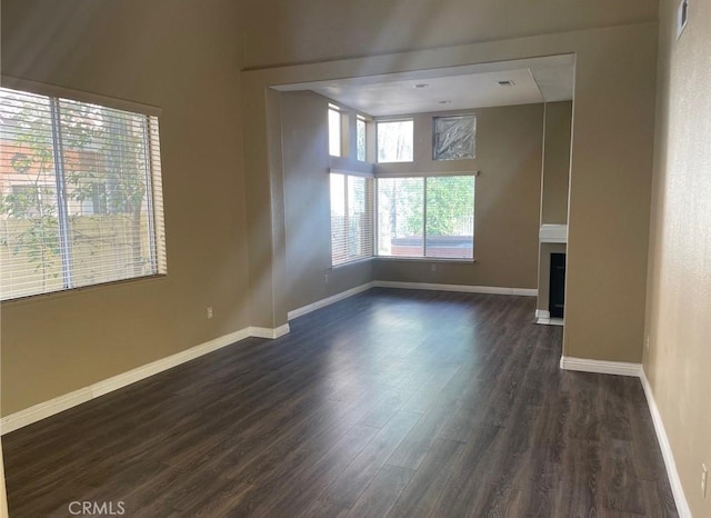 unfurnished room featuring dark hardwood / wood-style flooring