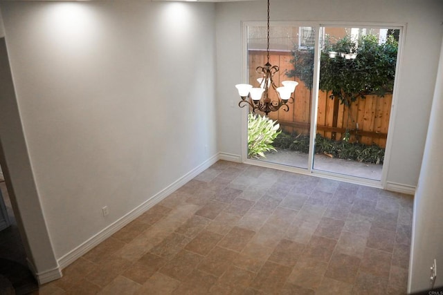 unfurnished dining area featuring an inviting chandelier