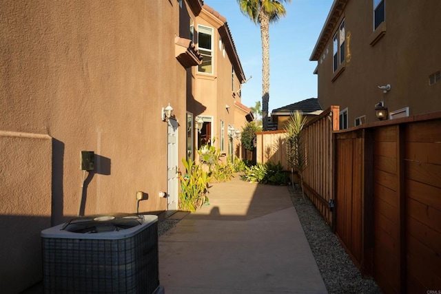 view of side of property with a patio and cooling unit