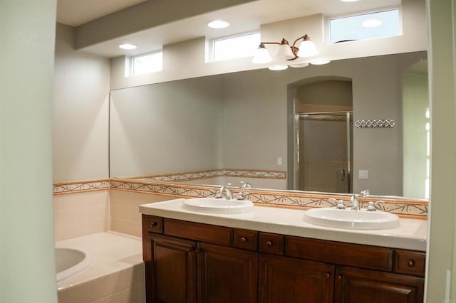 bathroom featuring separate shower and tub and vanity