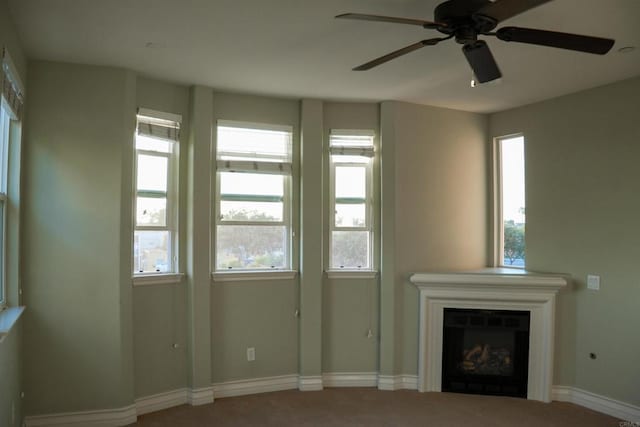 unfurnished living room with ceiling fan and carpet floors