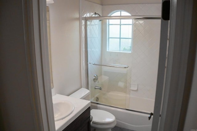 full bathroom with shower / bath combination with glass door, vanity, and toilet