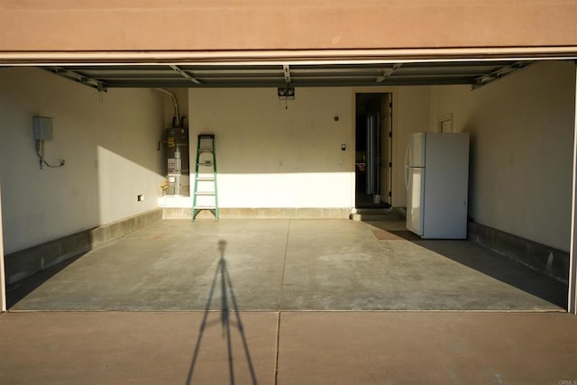 garage featuring white fridge and water heater