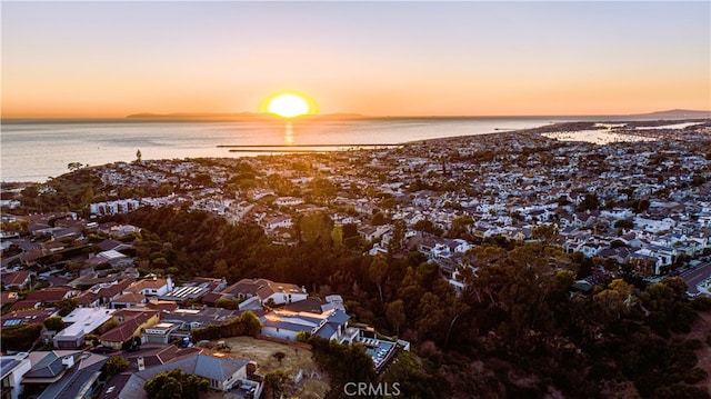 aerial view at dusk with a water view