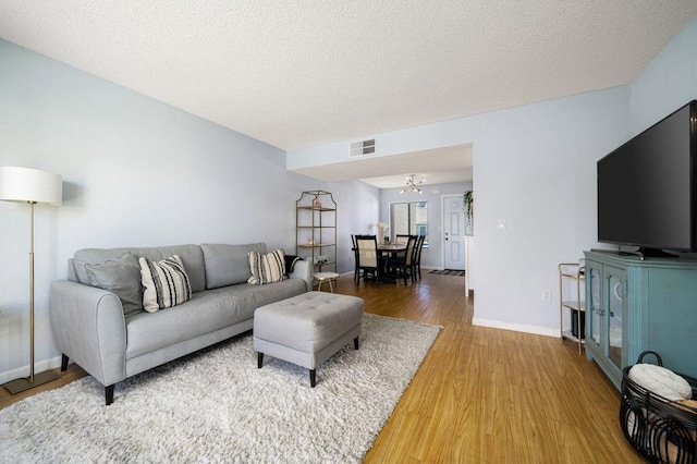 living room featuring hardwood / wood-style floors and a textured ceiling