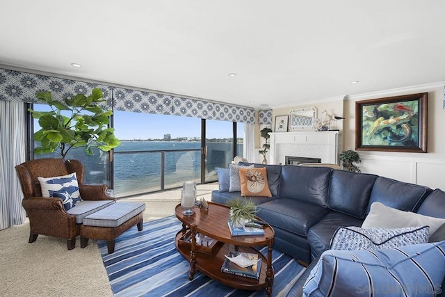 living room featuring a water view, ornamental molding, and carpet floors