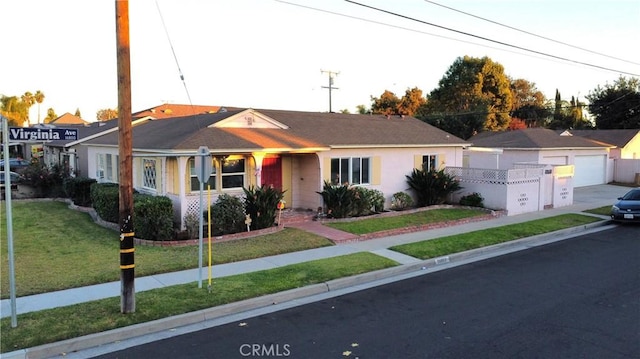 ranch-style house featuring a front yard and a garage