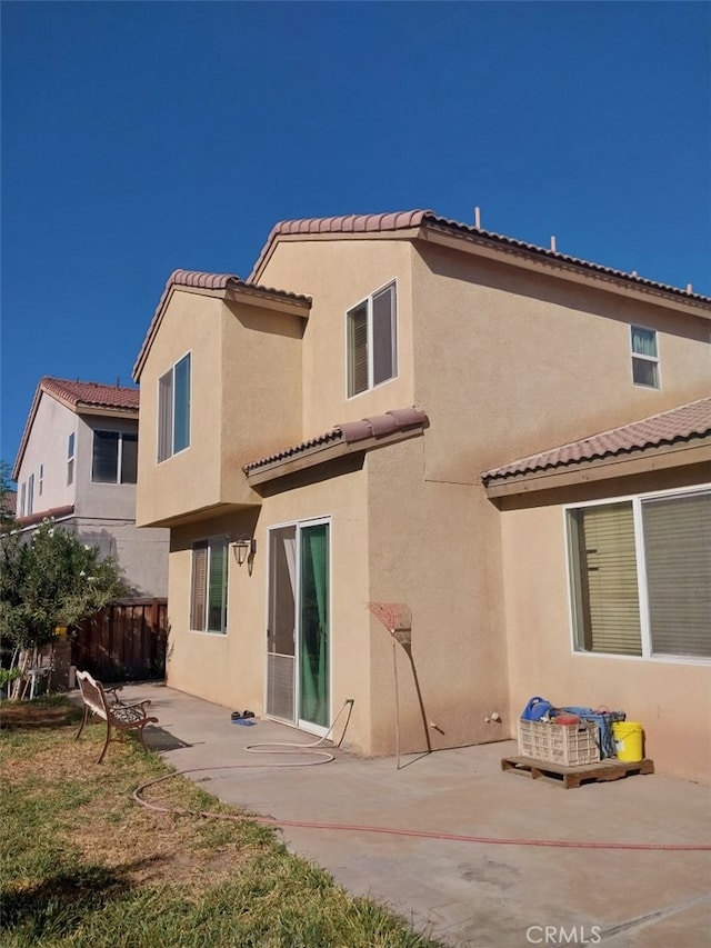 back of property with a patio