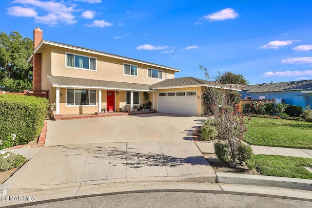 front of property with a front yard and a garage