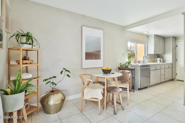 kitchen with gray cabinets, sink, light tile patterned flooring, and stainless steel dishwasher