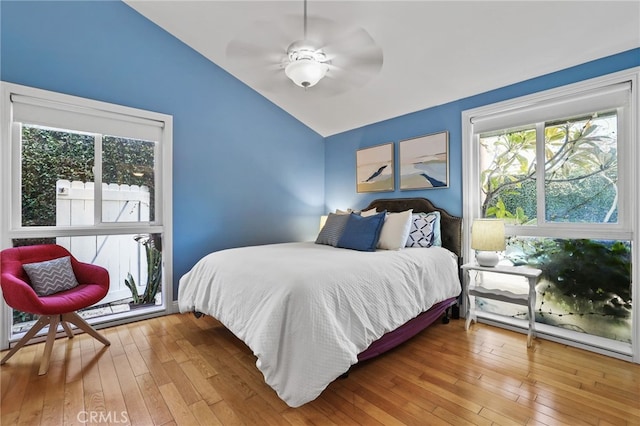 bedroom featuring ceiling fan, lofted ceiling, and hardwood / wood-style flooring