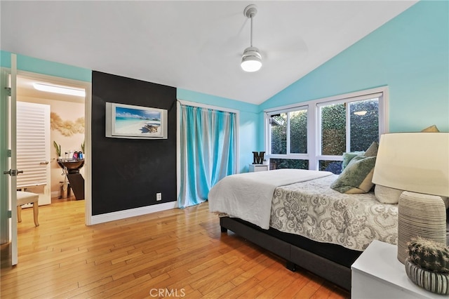 bedroom with lofted ceiling and light wood-type flooring