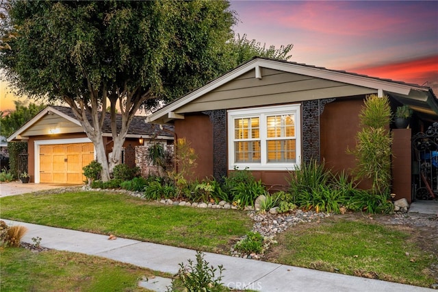 view of front of house with a yard and a garage