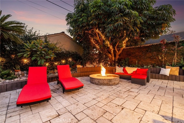 patio terrace at dusk featuring an outdoor fire pit