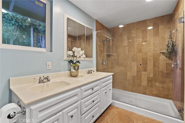 bathroom featuring tile patterned flooring, a shower with door, and vanity