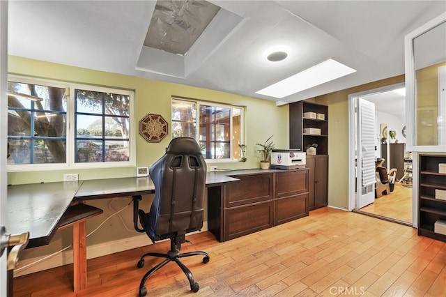 home office with light hardwood / wood-style floors