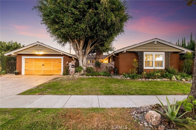 view of front of house with a garage and a yard