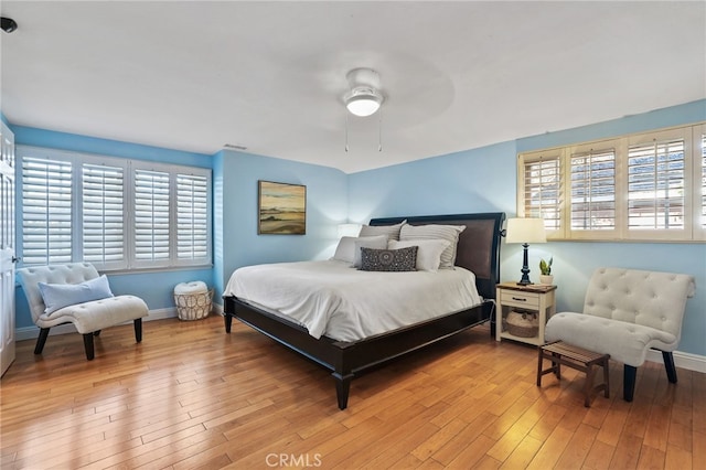 bedroom with ceiling fan and light hardwood / wood-style floors