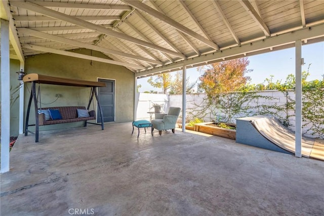 unfurnished sunroom with vaulted ceiling with beams