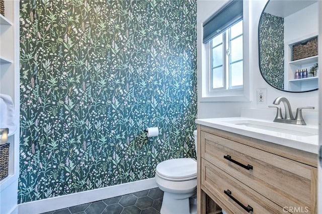 bathroom with tile patterned flooring, vanity, and toilet