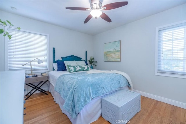 bedroom with ceiling fan and light hardwood / wood-style flooring