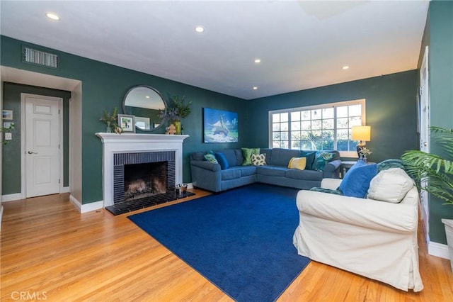 living room featuring a fireplace and hardwood / wood-style flooring