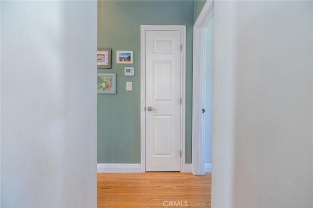 hallway with hardwood / wood-style floors